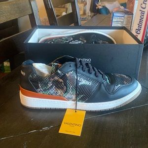Valentino sneaker snake print with black trim around sneakers and white sole